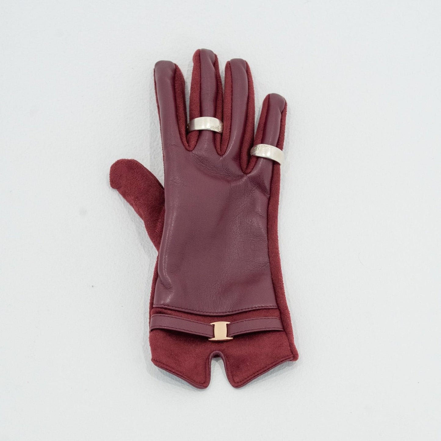 Maroon gloves with gold accents on a light gray background